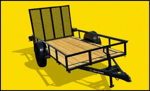 A black single-axle utility trailer with a wooden deck and mesh side gate on a yellow background.